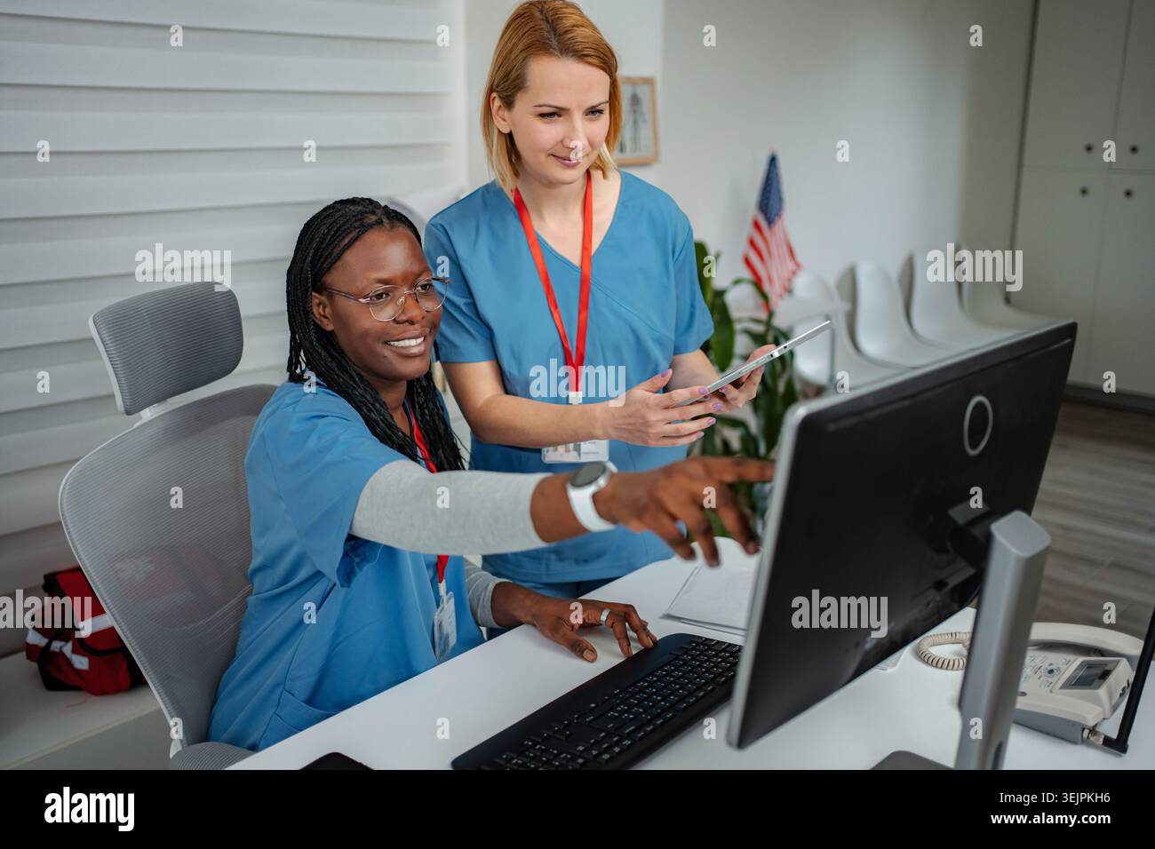 Diverse nurses collaborating accessing patient data using digital technology Stock Photo