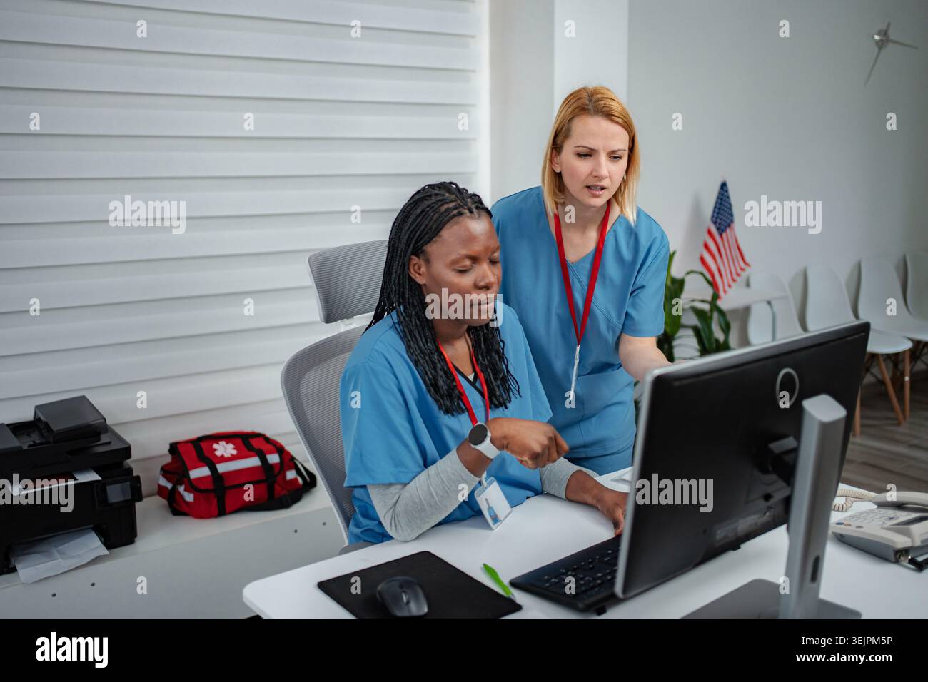 Medical professionals collaborating on computer in clinic office Stock Photo