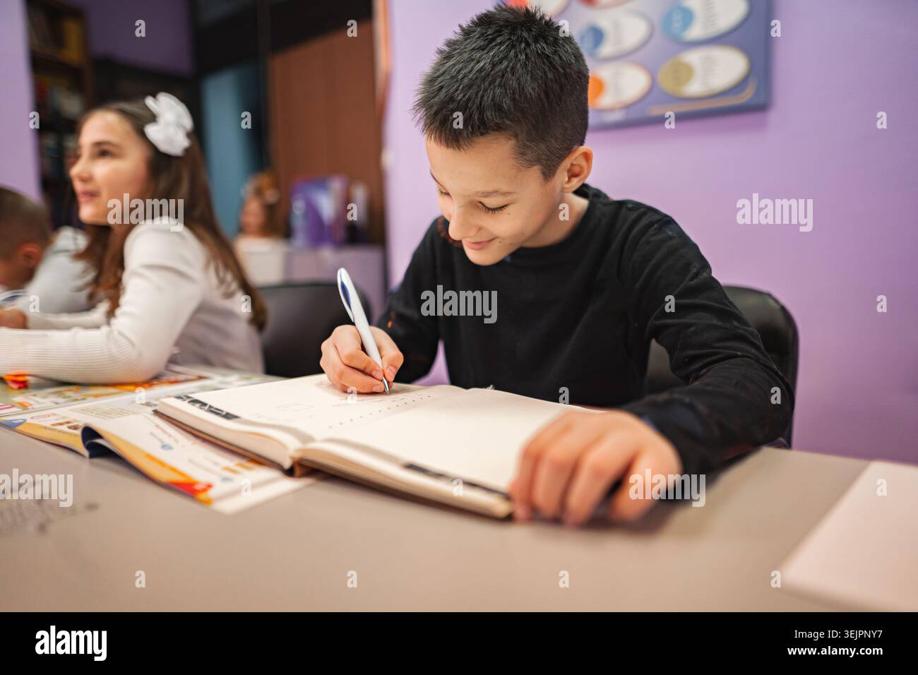 Two elementary students learning together at language school Stock Photo