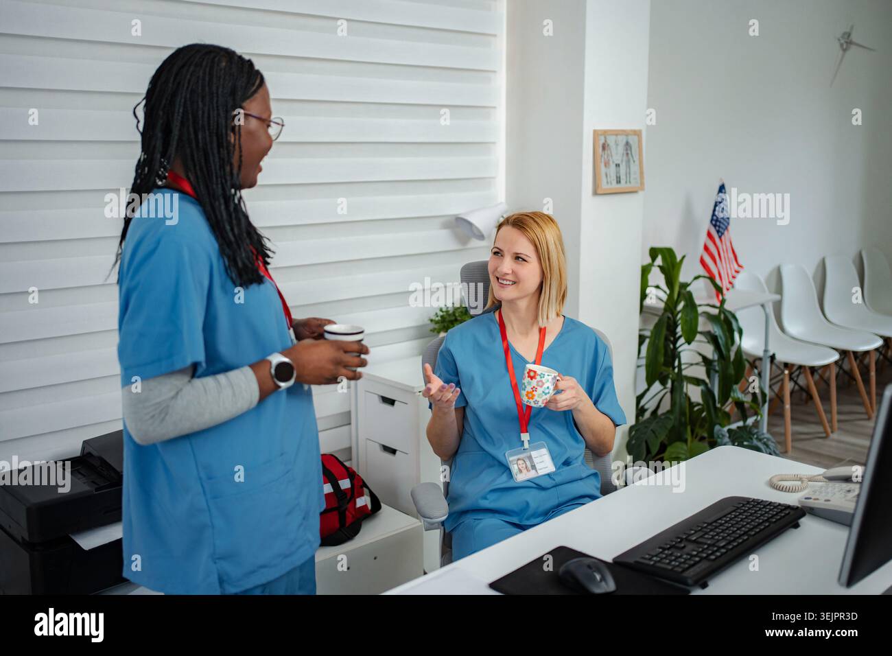 Healthcare workers enjoying coffee break discussing work Stock Photo
