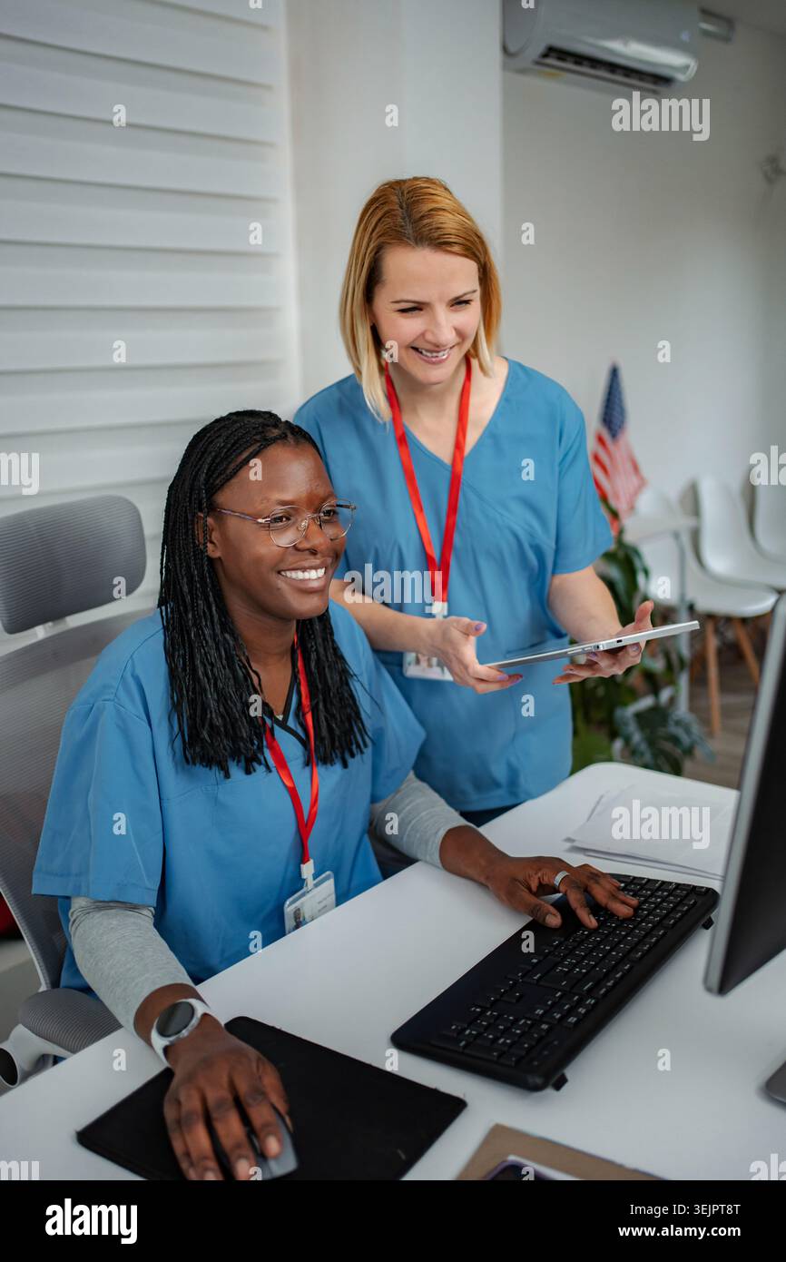 Healthcare professionals collaborating on computer using digital tablet Stock Photo