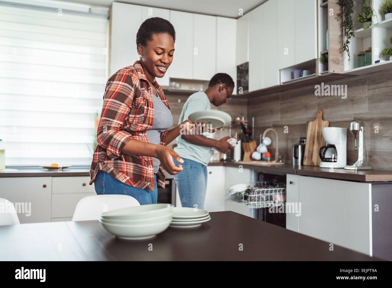 Couple Doing Dishes Together in Modern Kitchen Stock Photo