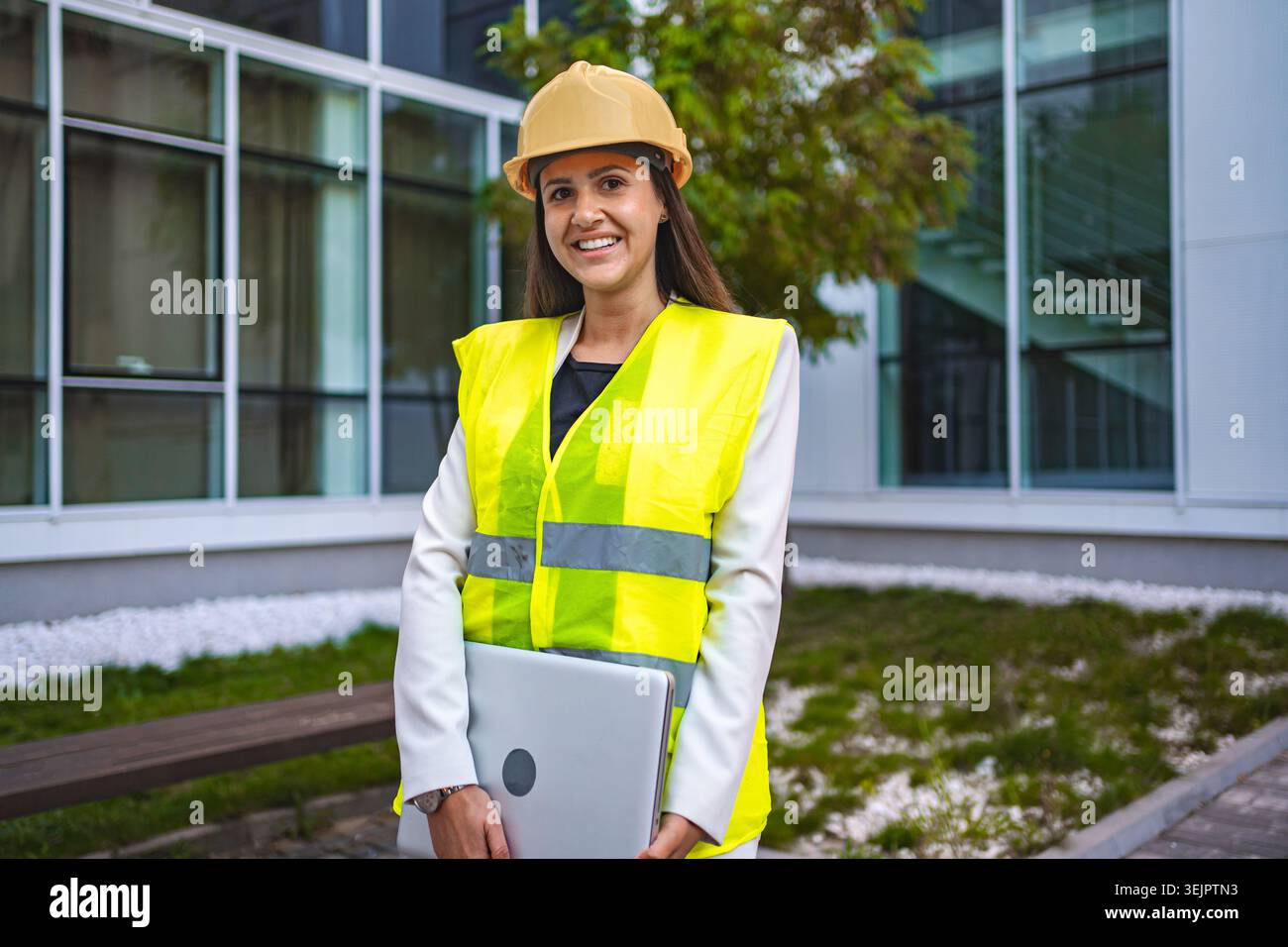 Smiling female safety engineer outdoors Stock Photo