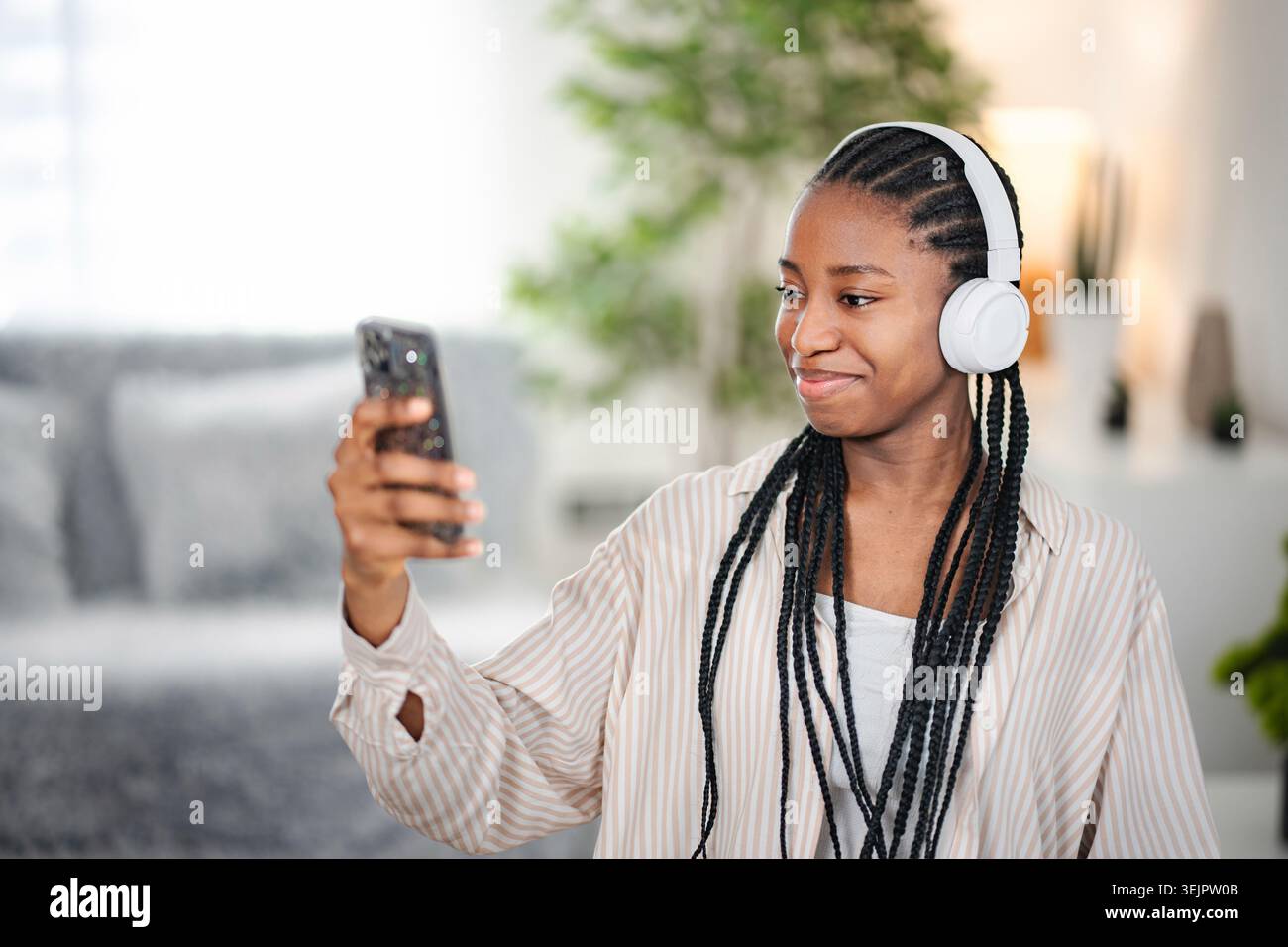 Young Black woman having video call using smartphone Stock Photo