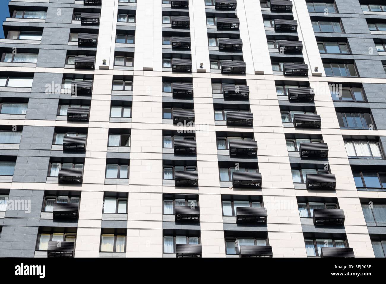Modern apartment building facade with repeating balconies pattern Stock Photo