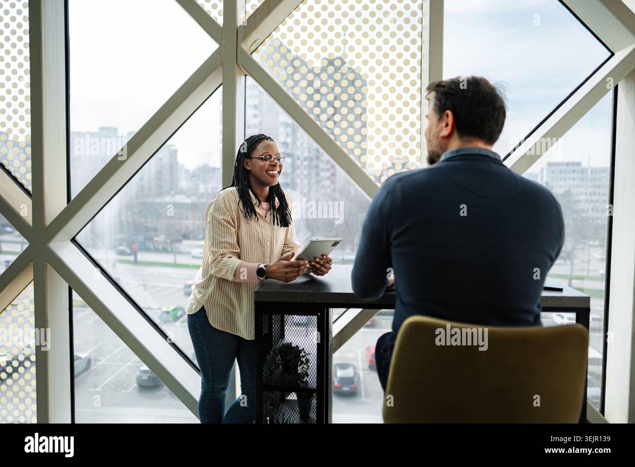 Business colleagues collaborating using digital tablet in modern office Stock Photo