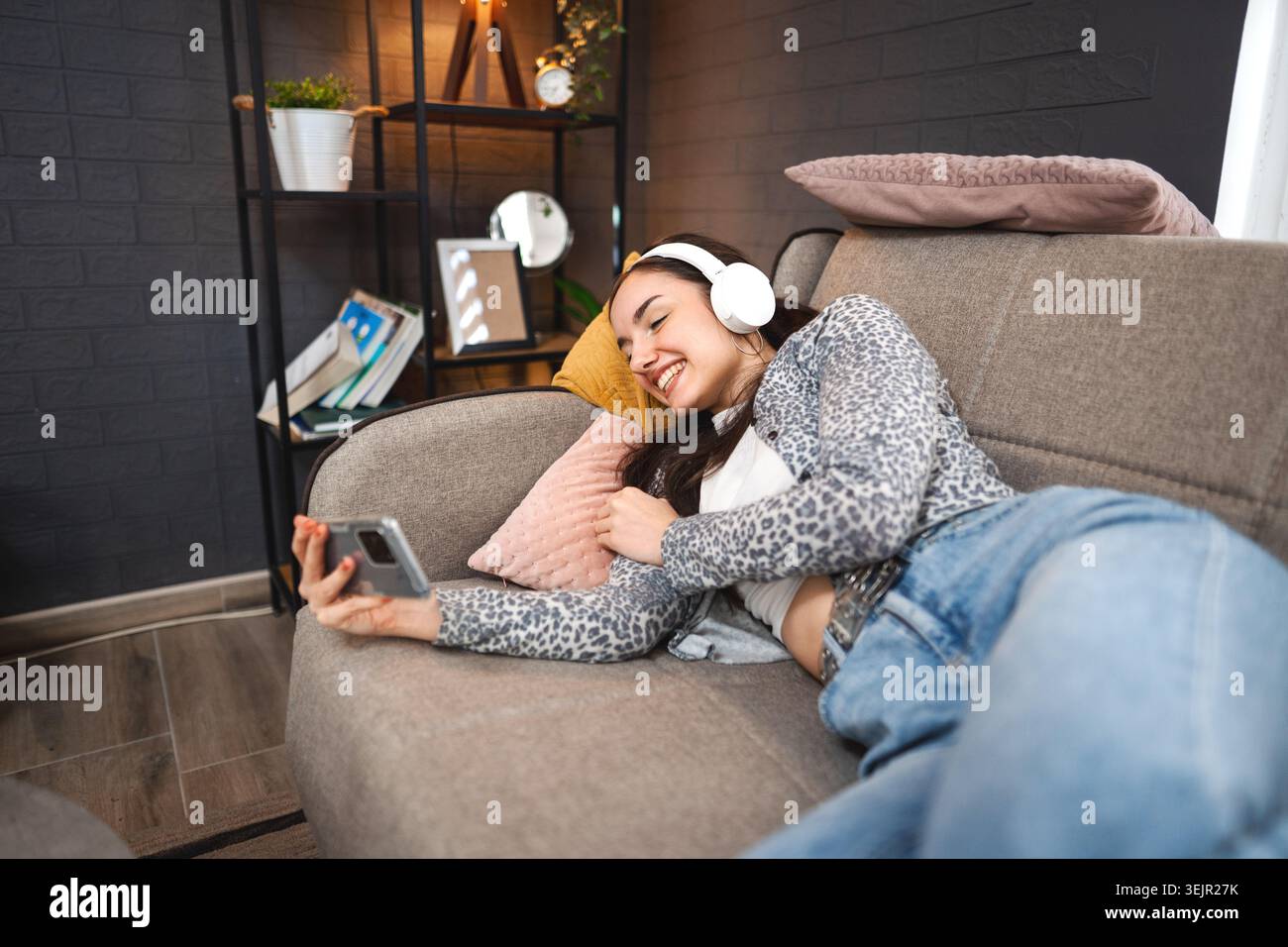 Relaxed young woman using mobile phone Stock Photo