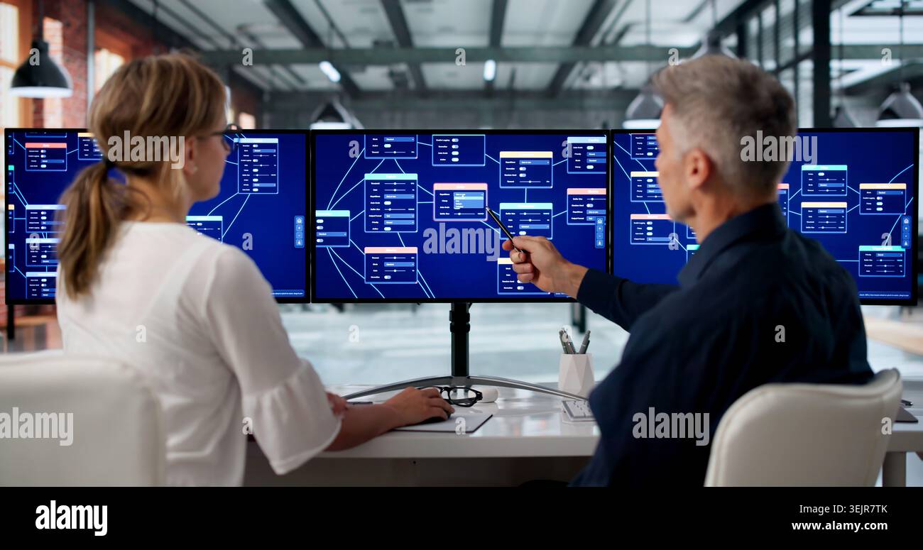 Two Software Developers Collaborate On Low Code Platform Using Drag And Drop Tools. Stock Photo