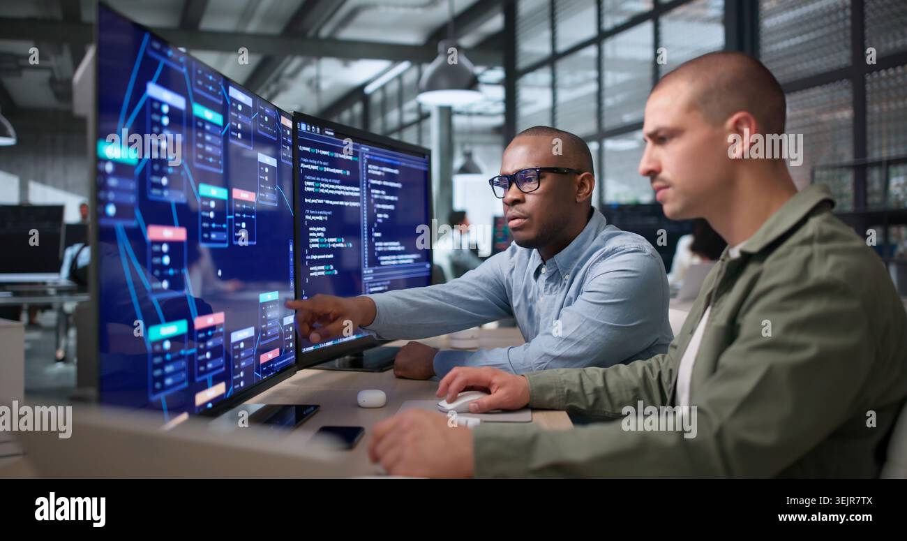 Two Young Black Men Collaborate On Visual Workflow Editor Using Software. Stock Photo