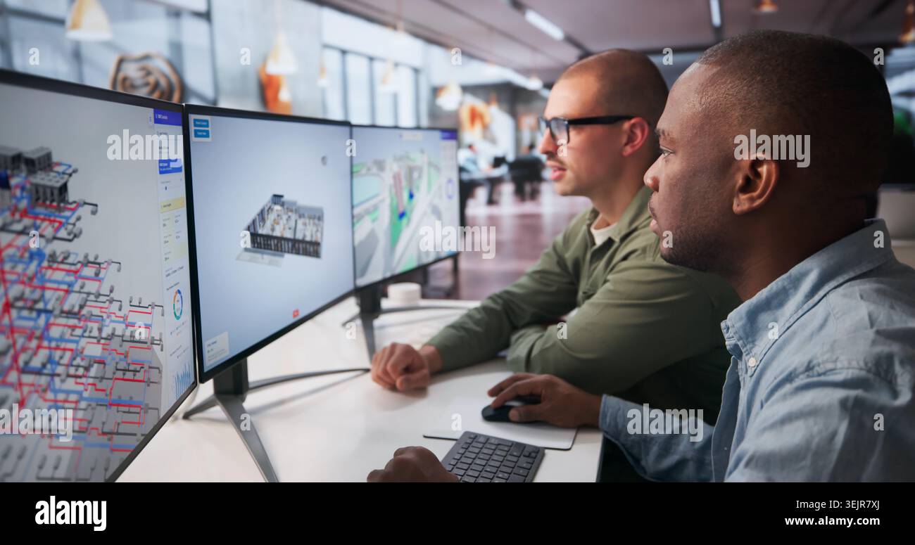 Two Engineers Working Together On 3D BIM Software For Building Design. Stock Photo