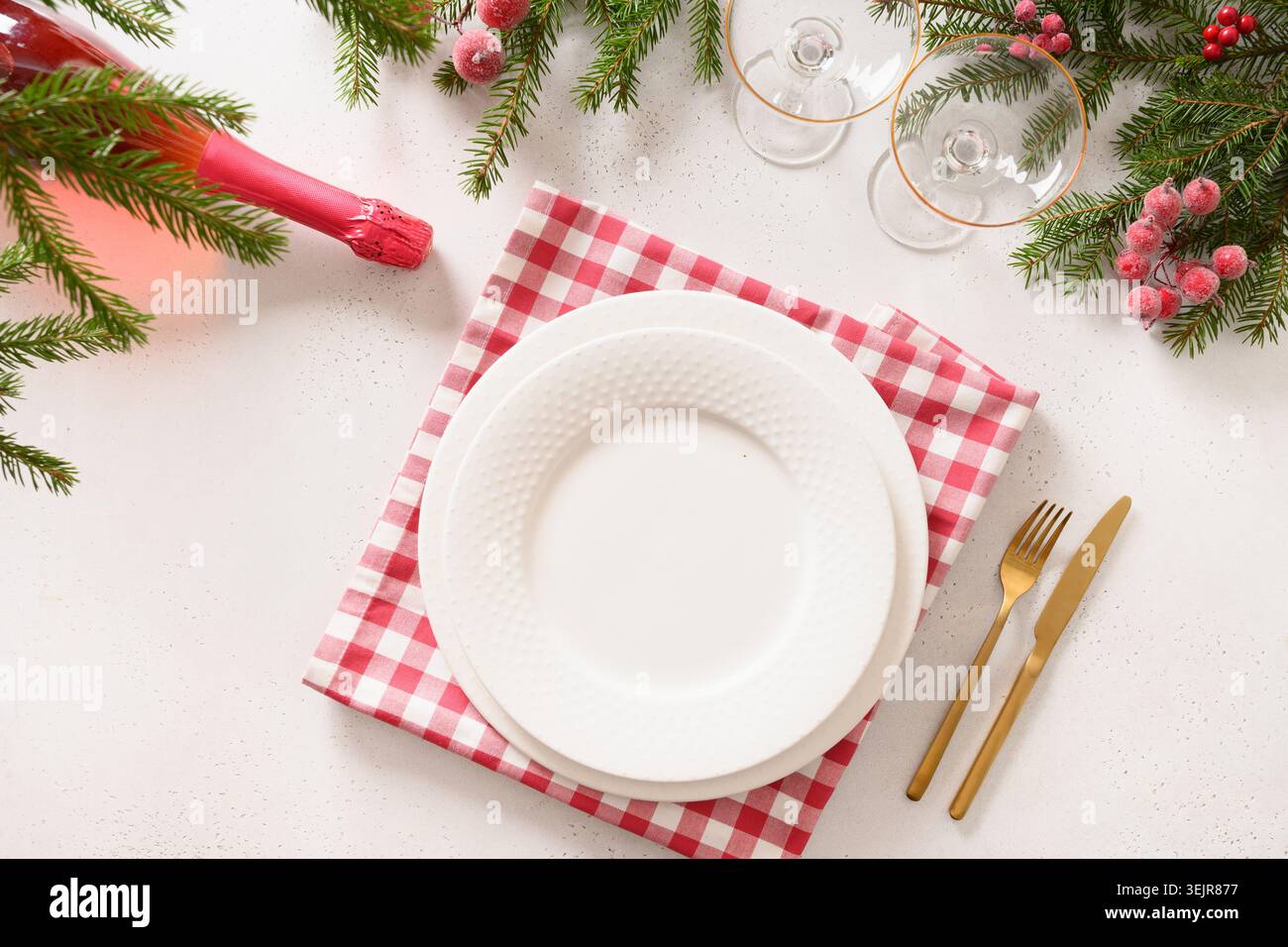Christmas table setting with elegant red decorations on white table. Stock Photo
