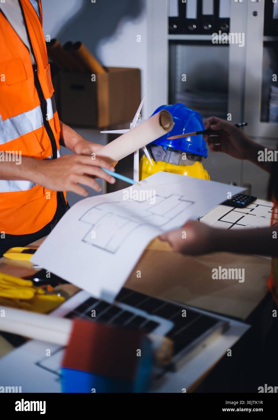 Two technicians inspect server racks in data center with tablet and fiber optic cable. Engineer and specialist discuss maintenance work in data center Stock Photo