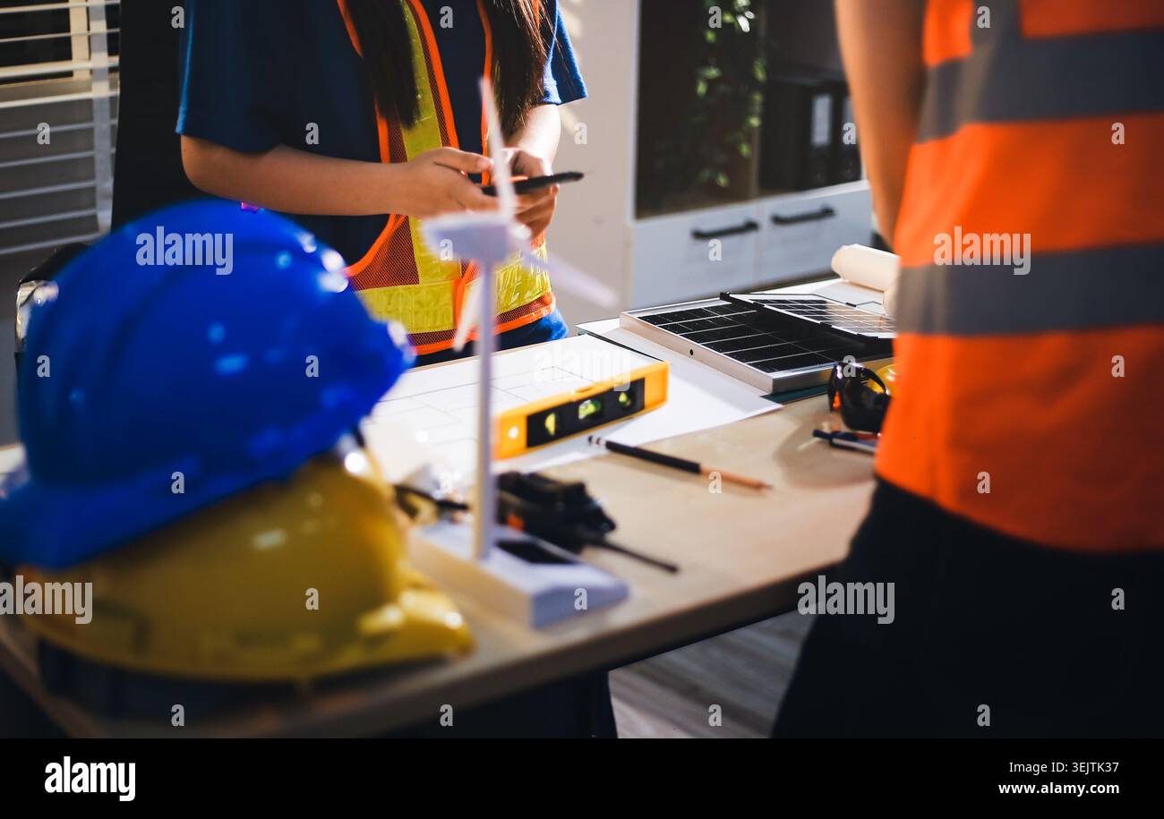 Two technicians inspect server racks in data center with tablet and fiber optic cable. Engineer and specialist discuss maintenance work in data center Stock Photo