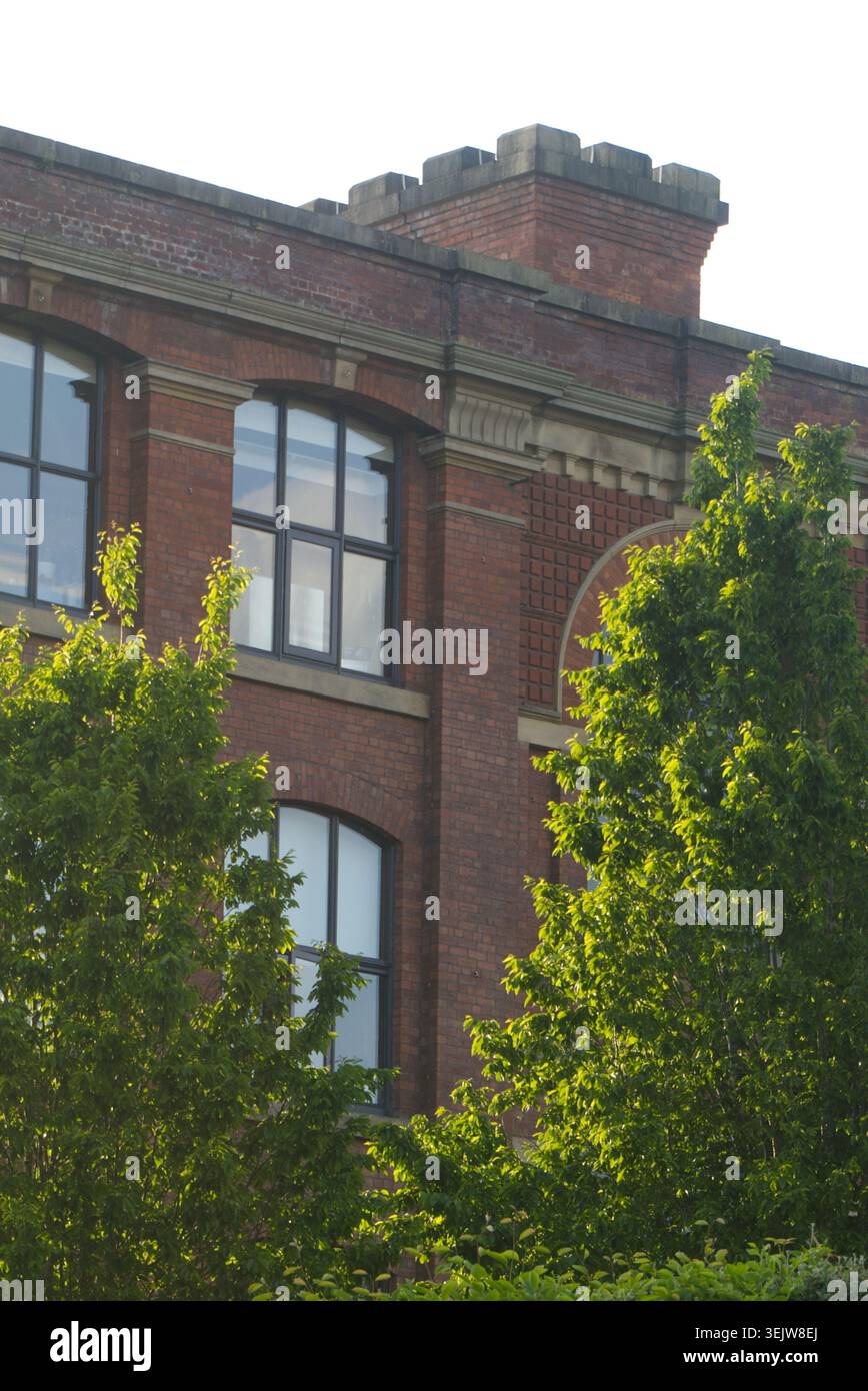Sunny Red Brick Victorian Building Facade with Large Windows Stock Photo
