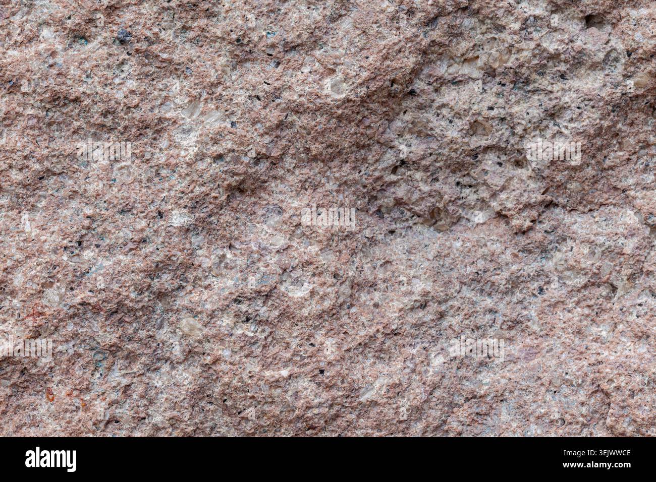 Pink granite stone wall background texture material macro Stock Photo