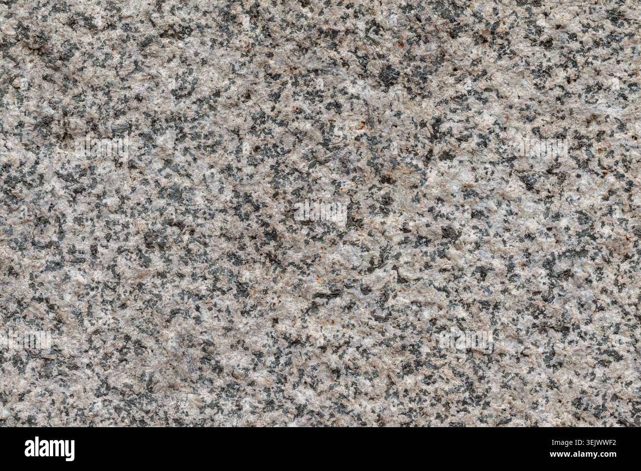 Roughly cut granite stone close up background texture material Stock Photo