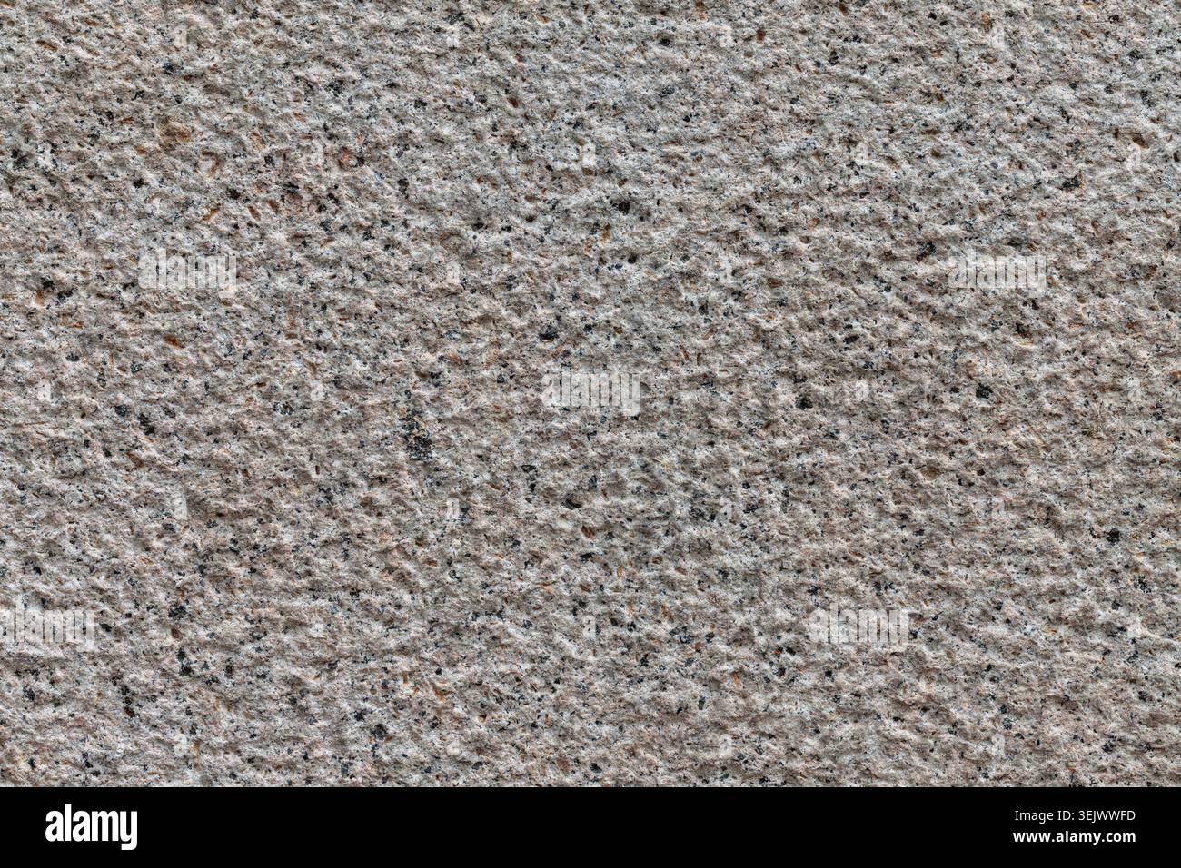 Uniformly chiseled granite stone background texture material macro Stock Photo