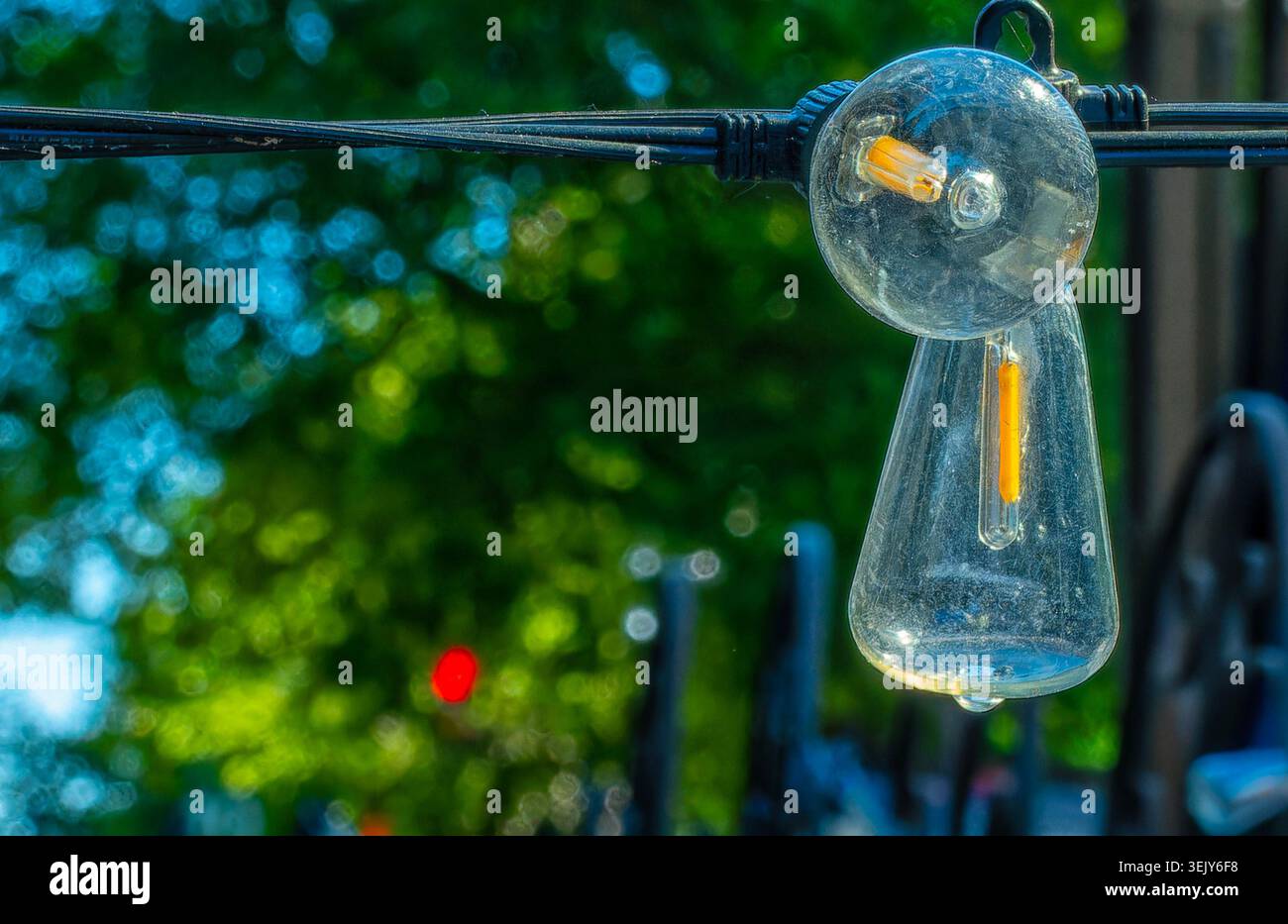 A string of festive light bulbs on a pation Stock Photo