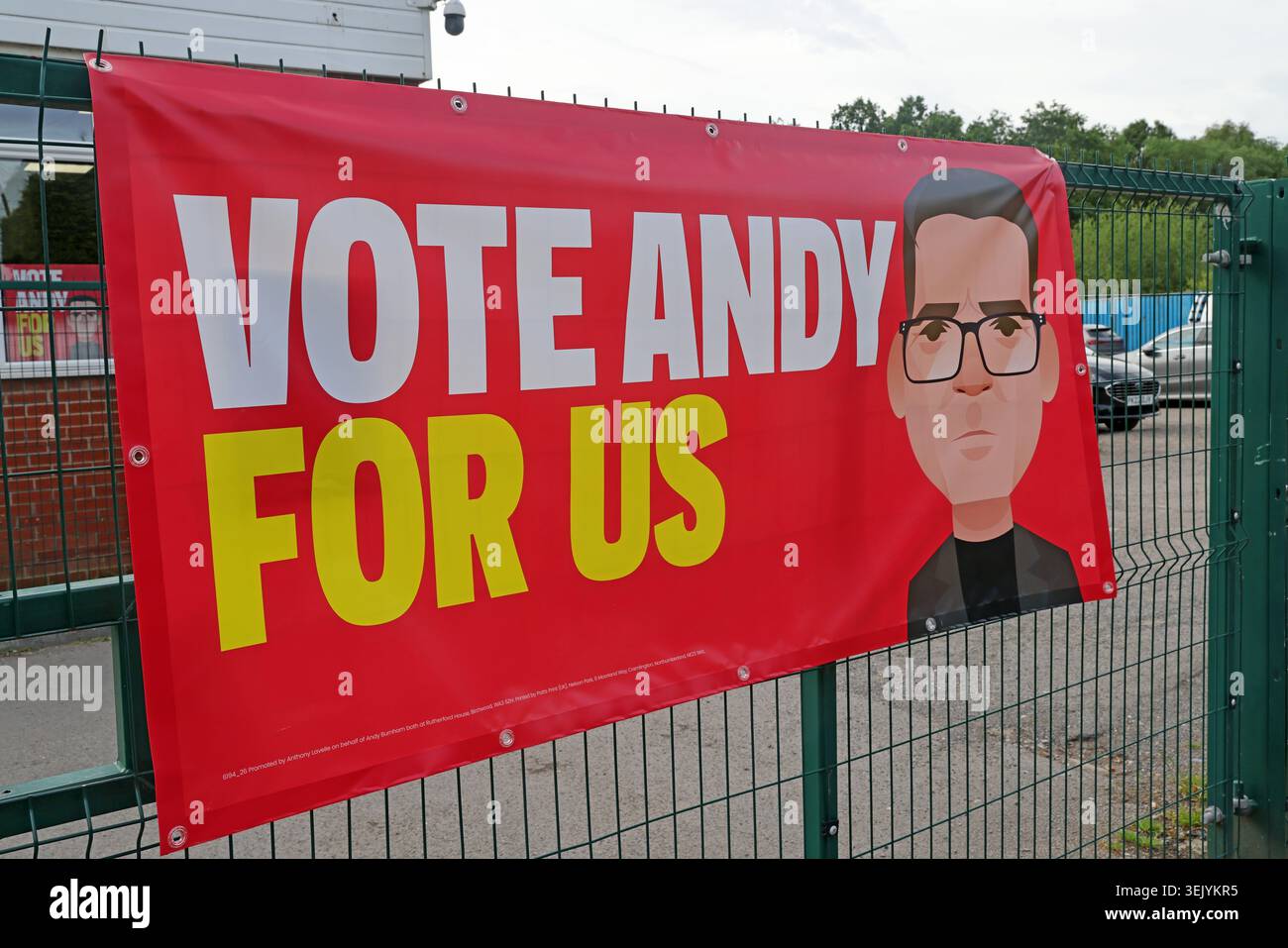 Red ‘Vote Andy For Us’ banner with cartoon portrait of Andy Burnham during the Makerfield by-election campaign, Ashton-in-Makerfield. Stock Photo