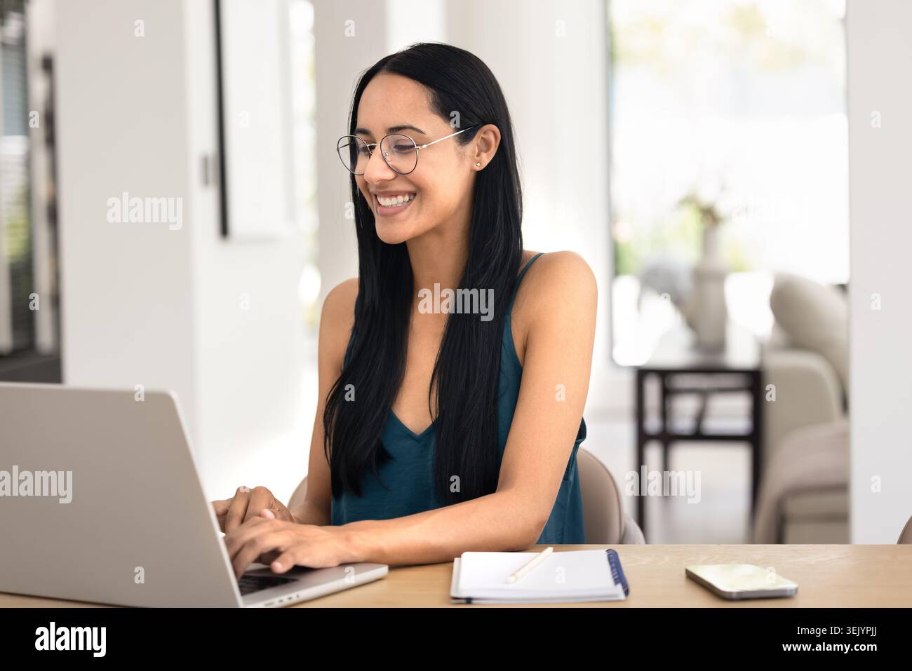 Woman working remotely on laptop at home Stock Photo