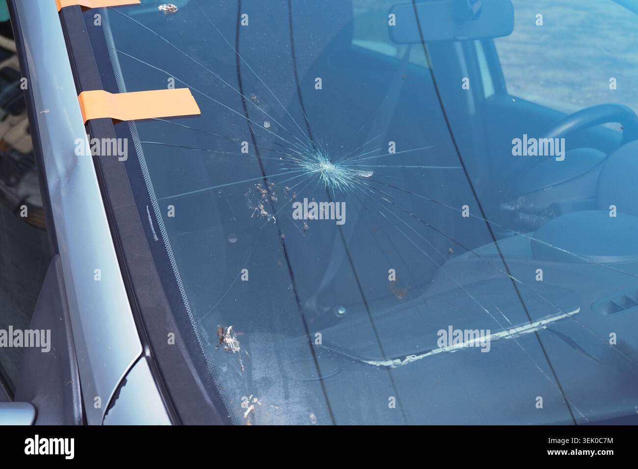 Windshield with cracks in a parked car at daytime Stock Photo