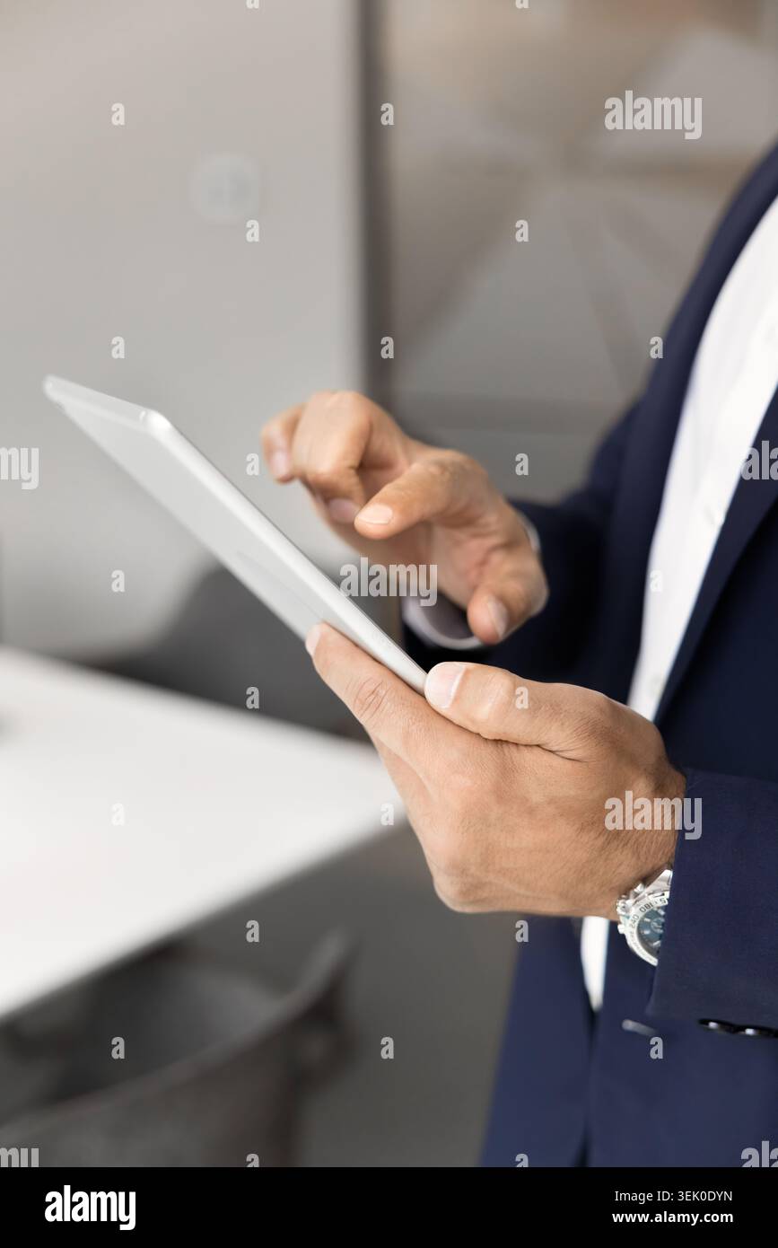 Businessman using digital tablet in office, close-up Stock Photo