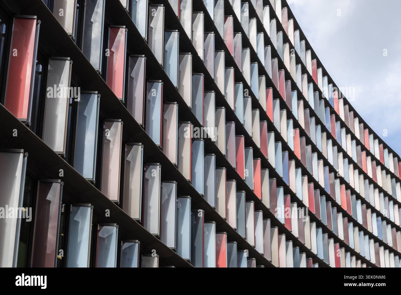 Modern curved office building facade with geometric window pattern Stock Photo