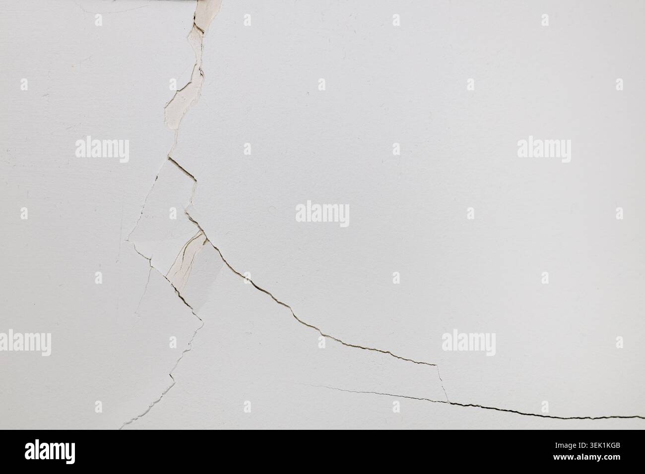 Large Structural Crack in White Plaster Wall Stock Photo