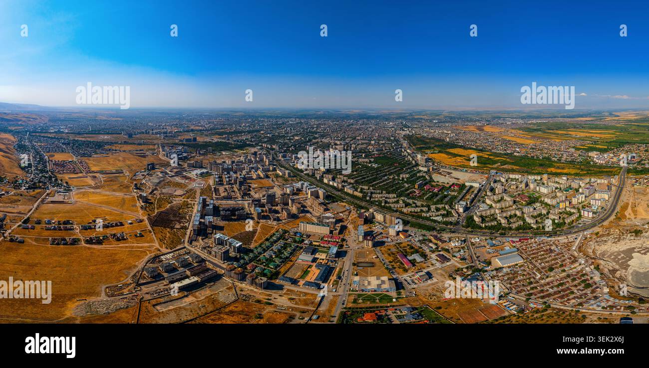 Aerial panorama captures Bishkek city in Kyrgyzstan under bright blue ...