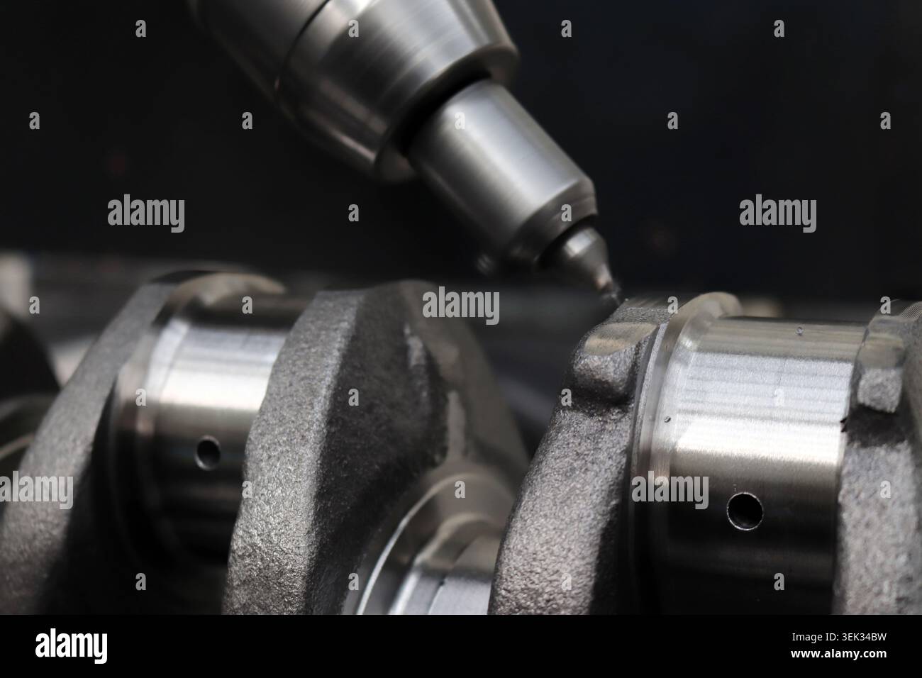 Engineers are working on the crankshaft. Stock Photo