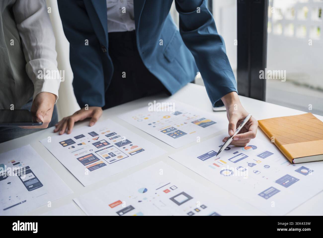 The development team brainstorms user interfaces and experience designs for the graphical UX UI graphics prototype for mobile applications Stock Photo