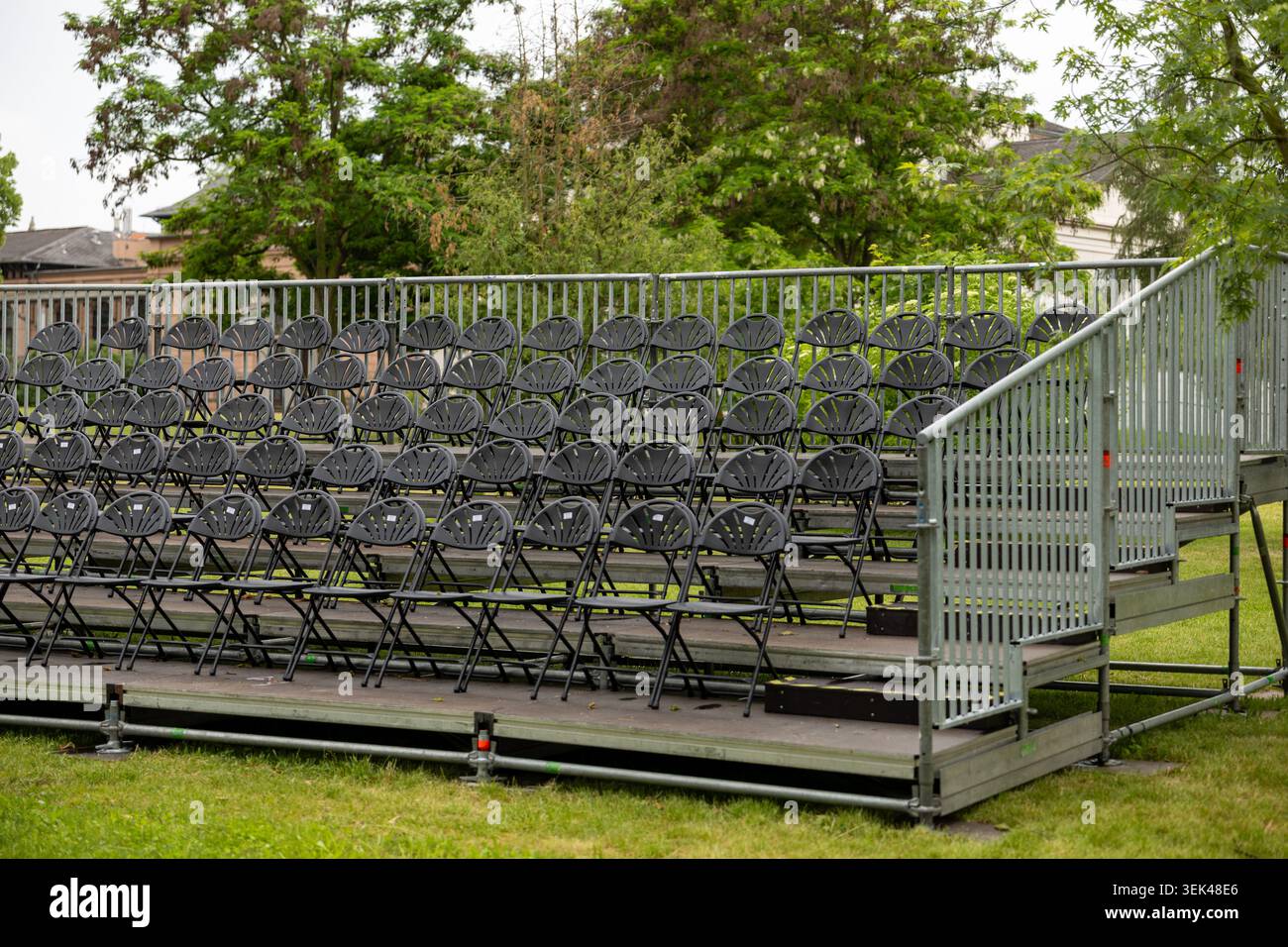 Outdoor Spectator Empty outdoor spectator grandstand with rows of folding chairs at event ...