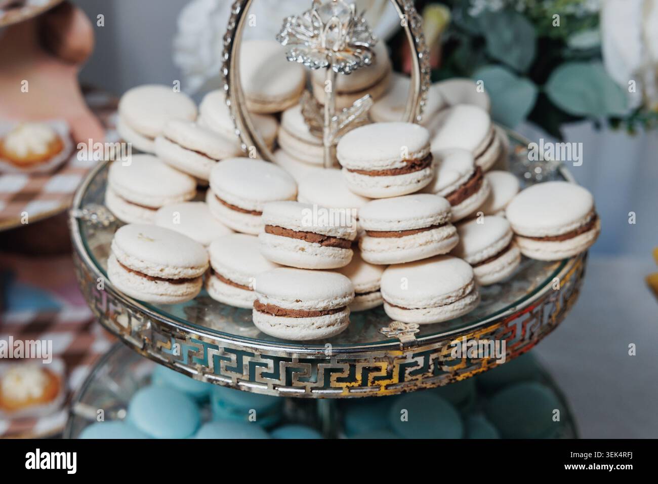 Elegant macarons stack on a decorative glass stand Stock Photo