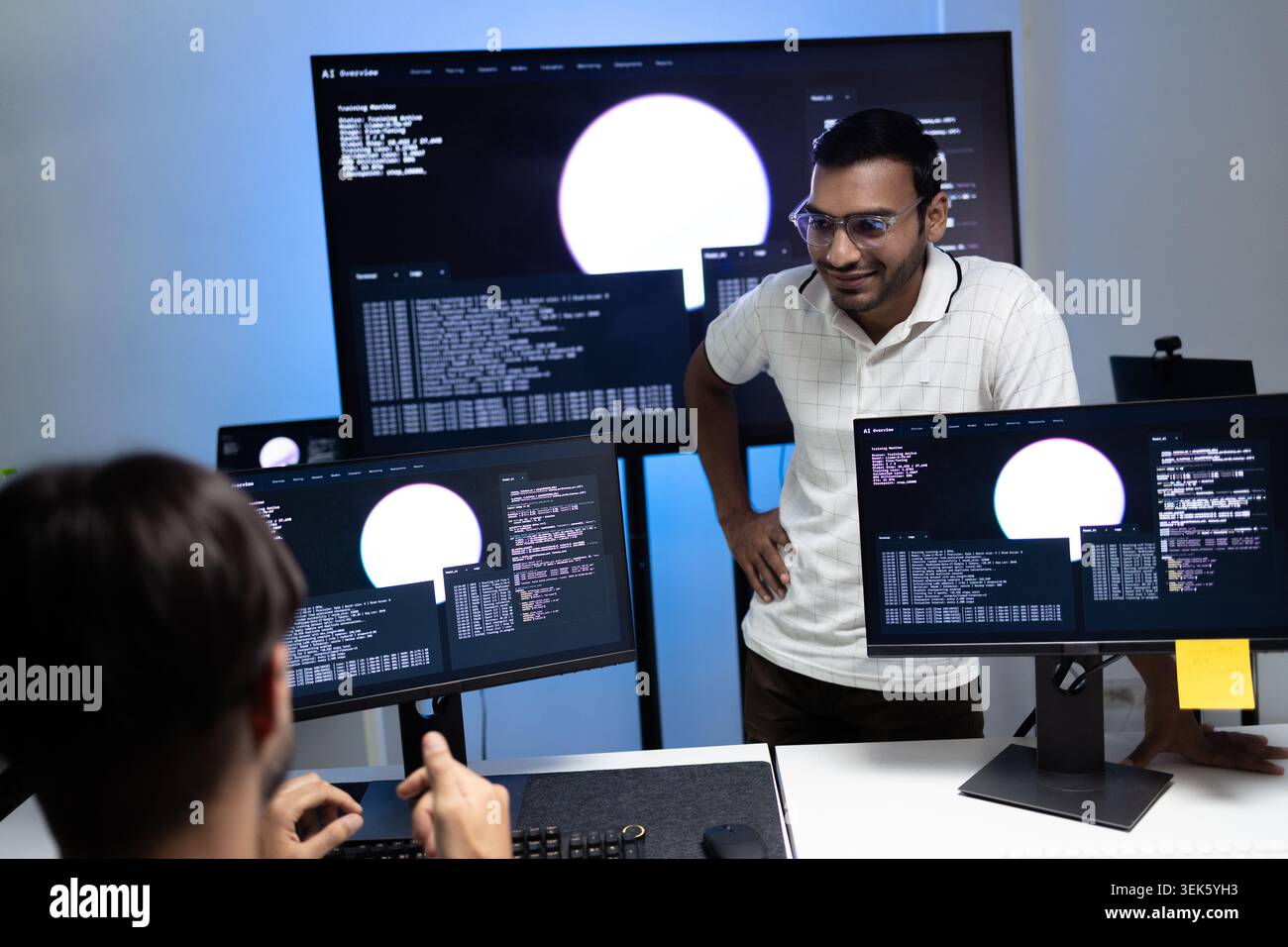 Coding Instructor Teaching AI Programming Lesson To Student In Tech Office Stock Photo