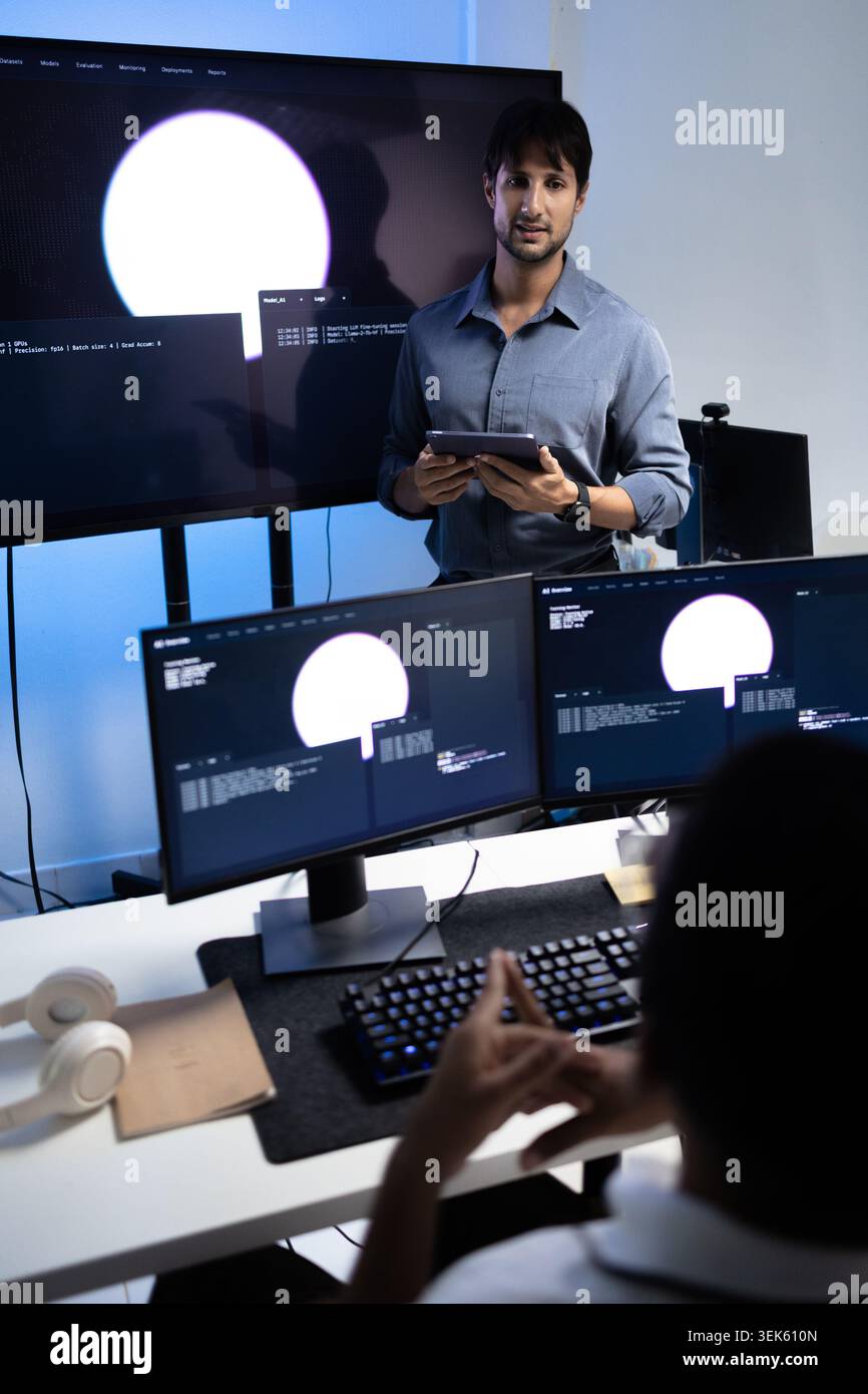Vertical View Of Programming Instructor Teaching AI Training Lesson In Tech Office Stock Photo