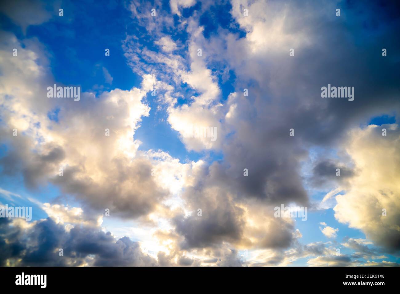 Dramatic Storm Clouds Against Vibrant Blue Sky Stock Photo