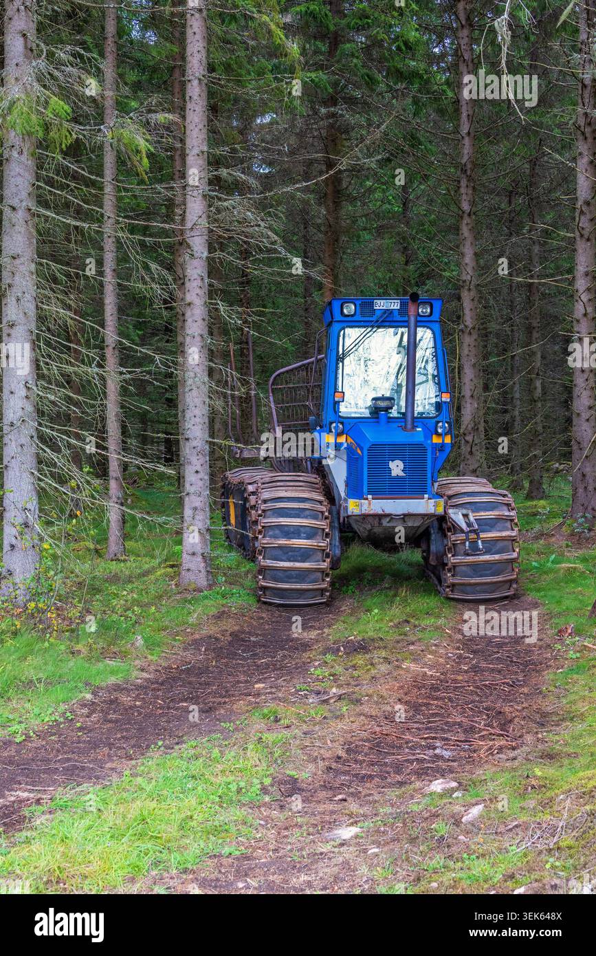 Forwarder on a logging road in a forest Stock Photo