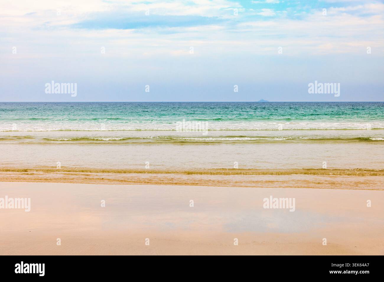 Breaking waves at a sand beach a summer day Stock Photo