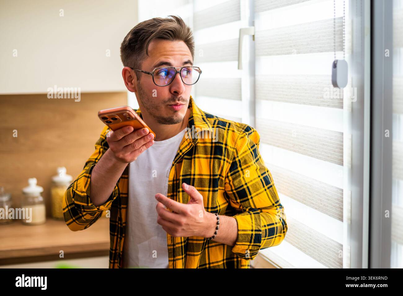 Man in yellow shirt talking hi-res stock photography and images - Alamy