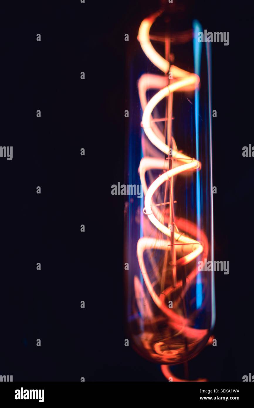 Cool light bulb glowing in the dark Stock Photo