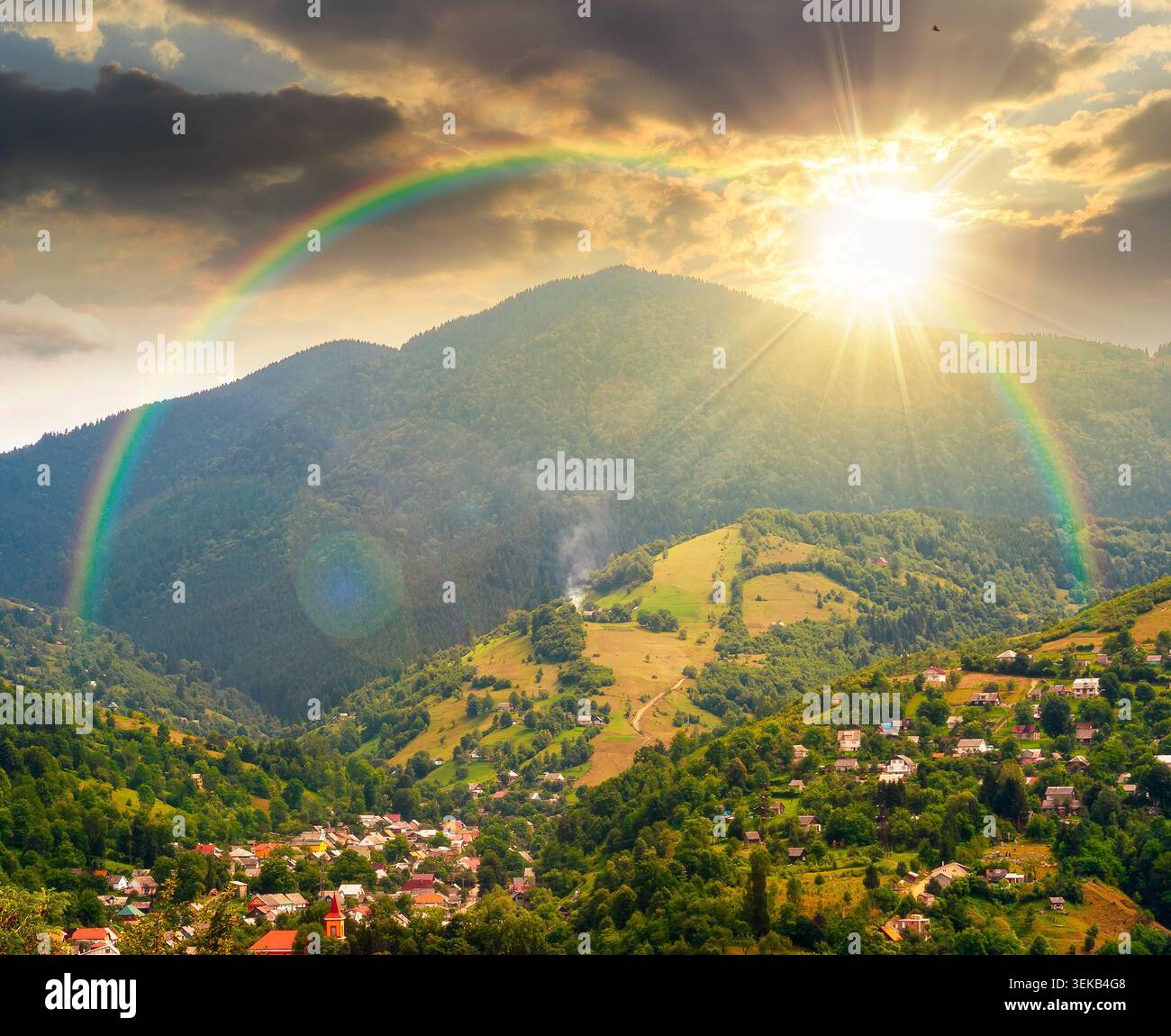 sunset over carpathian mountain landscape in summer. view in to the valley of rakhiv town near forested hill of mountain range. travel background of a Stock Photo