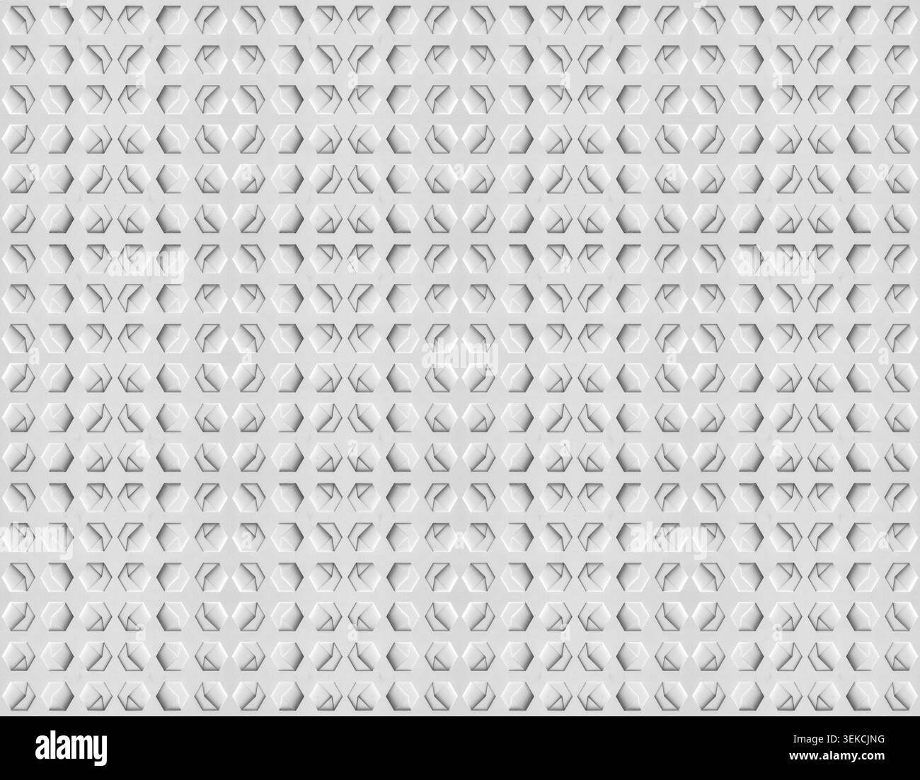 a white, textured surface featuring a grid of hexagonal indentations. Each hexagon has a three-dimensional, geometric design with internal triangular Stock Photo