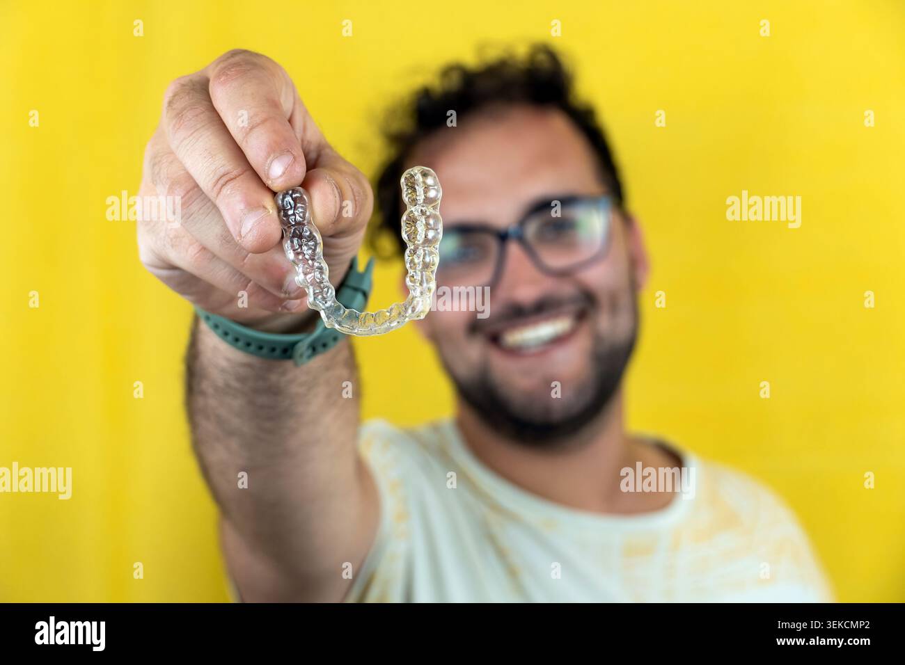 Man holding clear aligners for teeth straightening Stock Photo