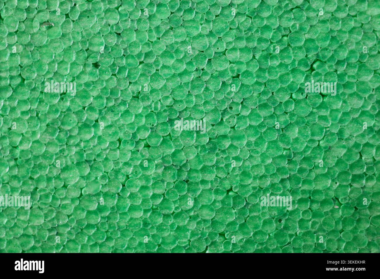Green Polystyrene Foam Texture Background, Close Up Macro Pattern of Expanded Styrofoam Surface for Packaging and Construction Stock Photo