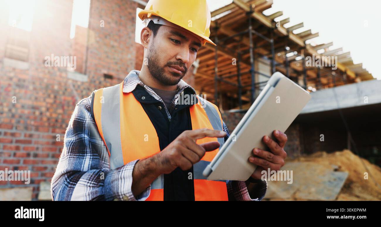 Civil engineer, online and man with tablet at construction site, scroll or project update on website. Outdoor, architect and person with tech for Stock Photo