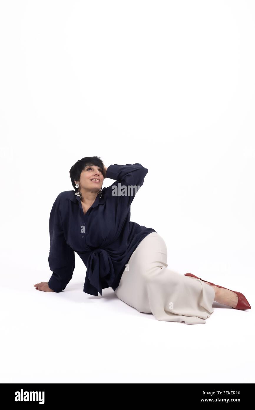Athletic young man lying relaxed on floor leaning back looking up Stock Photo