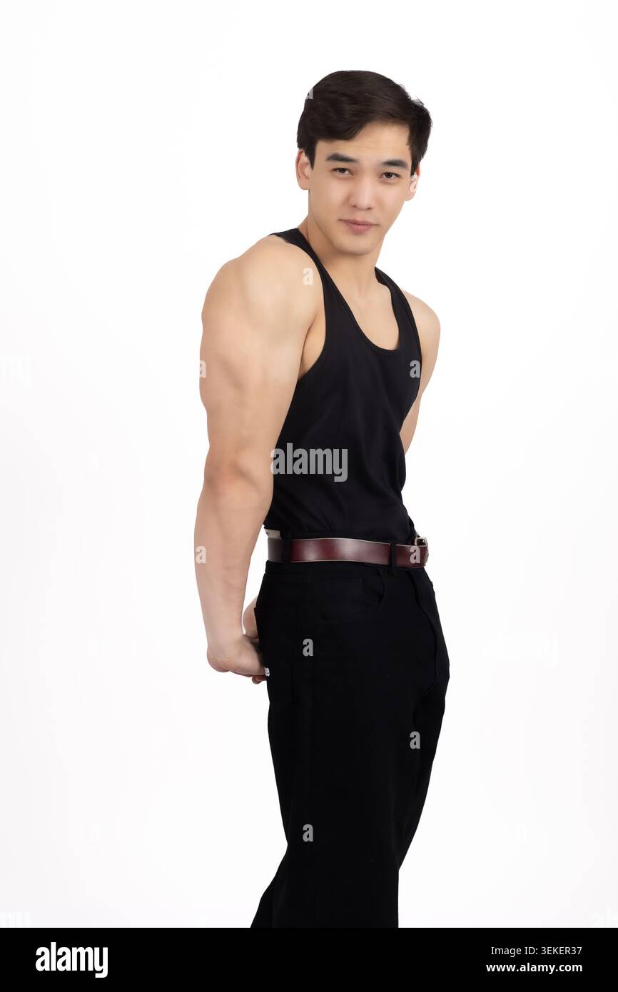Athletic young man standing side profile looking at camera confidently Stock Photo