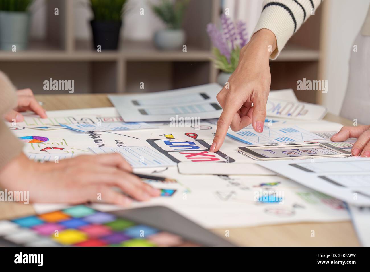 Women designers collaborating on UI UX mobile app wireframe planning Stock Photo