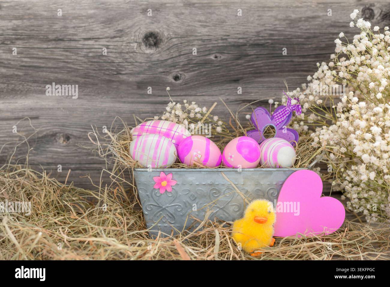 Easter decorations, pink Easter eggs in a flower box with Easterchick and heart Stock Photo