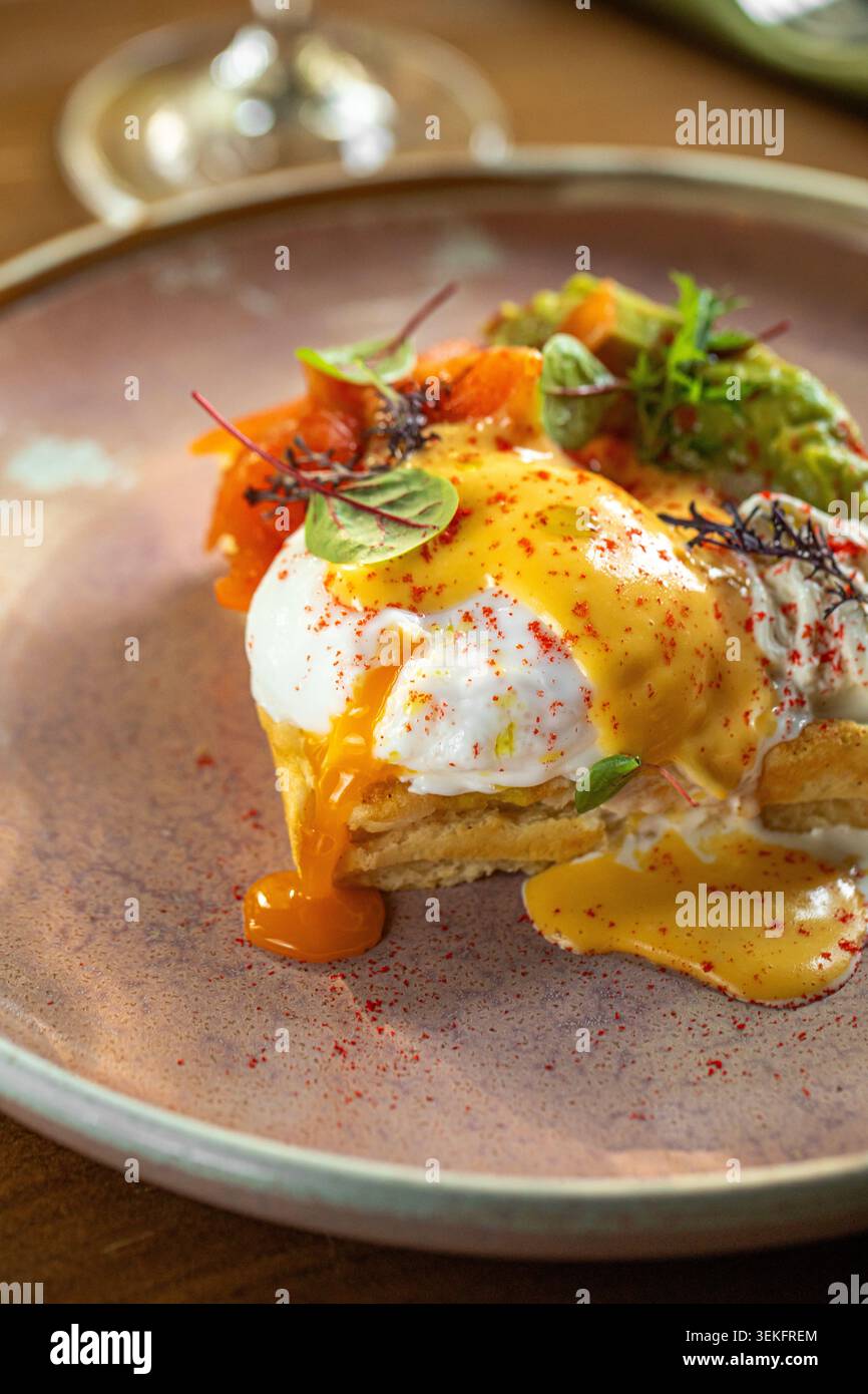 Gourmet eggs benedict with creamy sauce plating Stock Photo